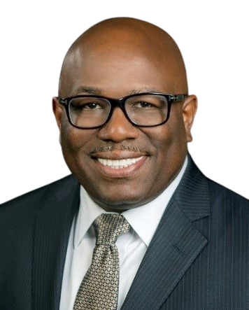 A man in a suit and tie smiling for the camera.